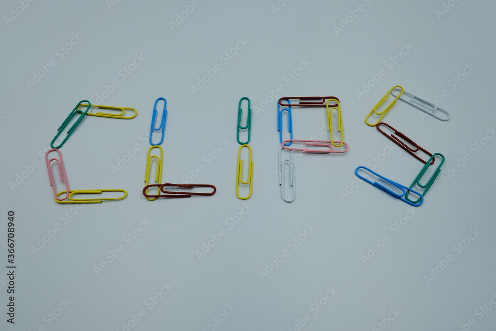 Text letter CLIPS by paper clips multicolor on white background, office business work or education concept Text letter CLIPS by paper clips multicolor on white background, office business work or education concept