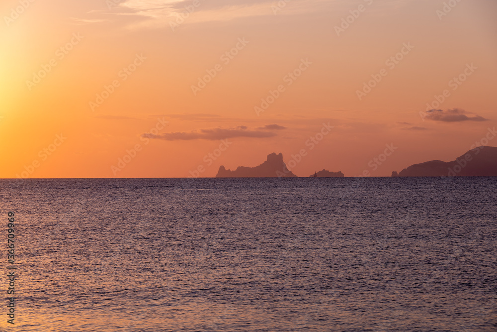 The magic, famous rock of Es Vedra, Ibiza, from the port of Formentera. Ibiza's most popular icon and symbol, said to be magic and mysterious. Soft warm sunset light.