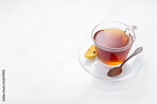 Black tea in a glass cup on a white background