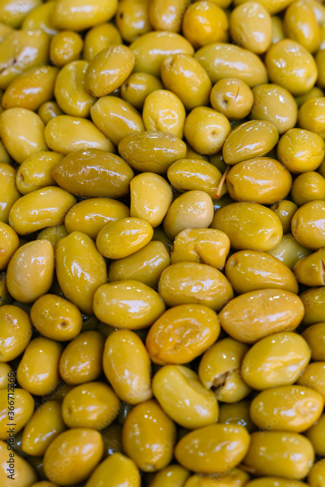 Vertical photo of a pile of green olives Vertical photo of a pile of green olives