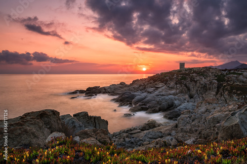 Fototapeta Naklejka Na Ścianę i Meble -  Sun rising behind genoese tower in Corsica