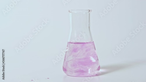 Wallpaper Mural Lab research. Chemical test. Pink liquid sample mix motion in glass laboratory flask isolated on white copy space. Torontodigital.ca