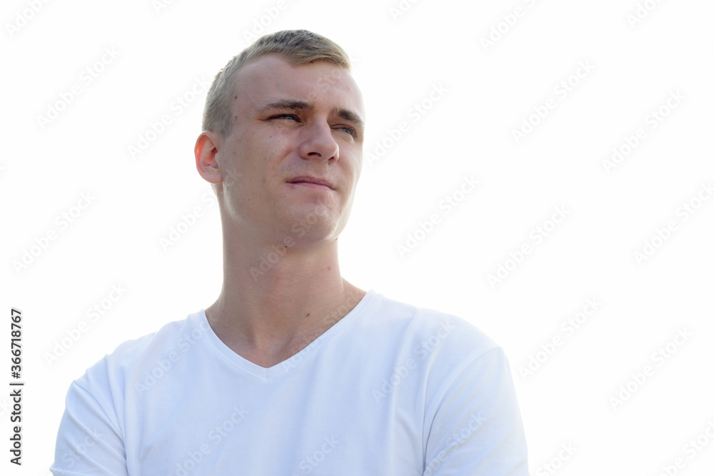 Portrait of young blond man against view of the clear sky
