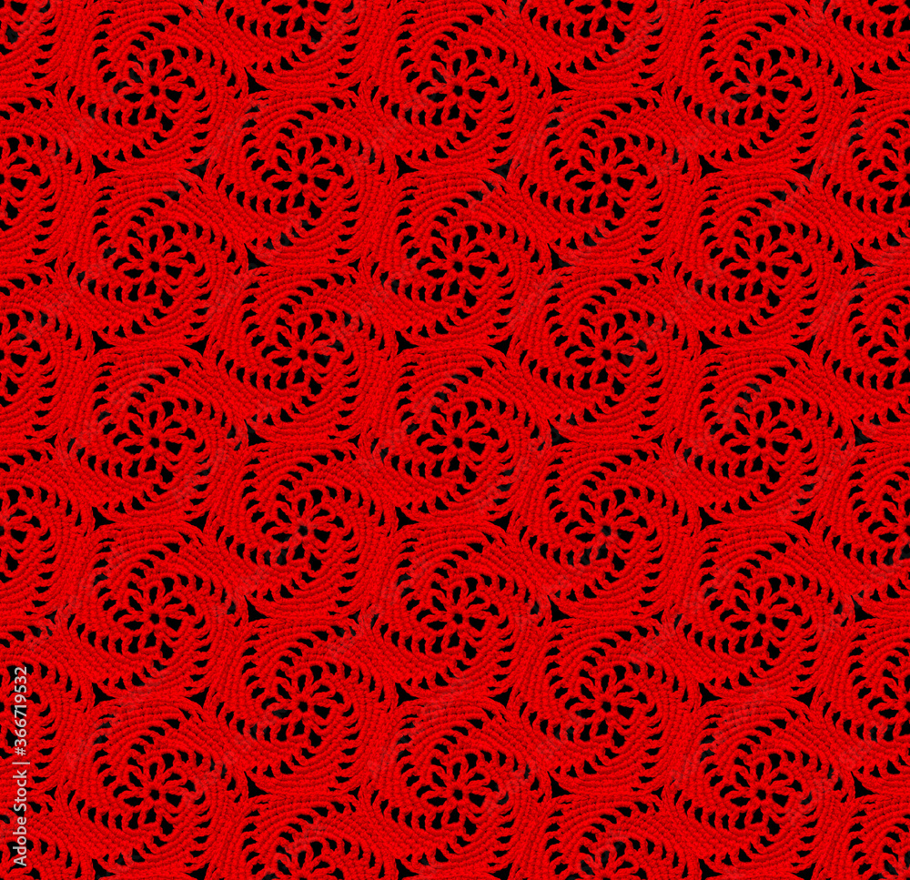 Seamless openwork knitted texture. The pattern in the form of spirals is crocheted with red threads. Cotton yarn. Seamless openwork knitted texture. The pattern in the form of spirals is crocheted with red threads. Cotton yarn.