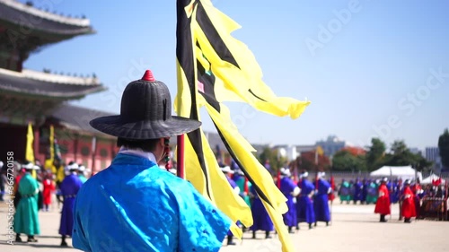 Slow motion of royal guard holding flag at Gyeongbokgung Palace photo