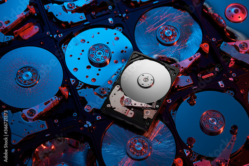 Opened broken hard disks pattern with red and blue lighting photo