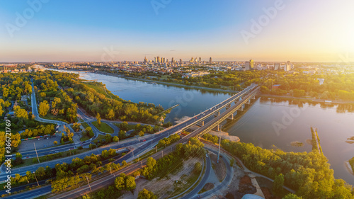 Warsaw city center lit by setting sun aerial view