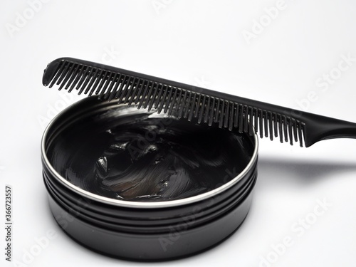 Hair pomade or waxe and comb isolated on white background photo