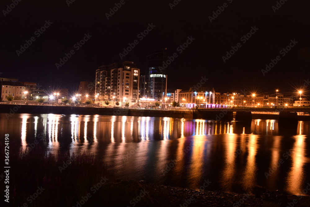 Long Exposure view of a city with reflection on water. None of the pictures edited in post. (Can Provide .NEF (RAW) Files upon request.)
