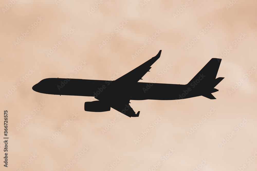 silhouette of the airplane in the evening sky silhouette of the airplane in the evening sky