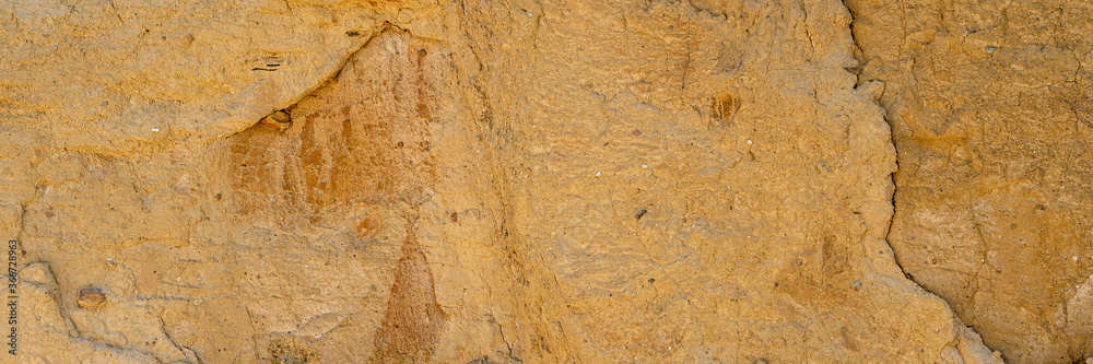 Background, a natural sandstone wall on a seaside cliff. Sandstone overlay Background, a natural sandstone wall on a seaside cliff. Sandstone overlay