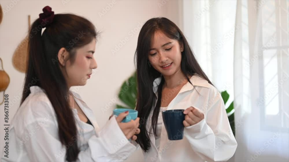 Enjoyment lesbian couple is talking and relaxing with morning coffee. Enjoyment lesbian couple is talking and relaxing with morning coffee.