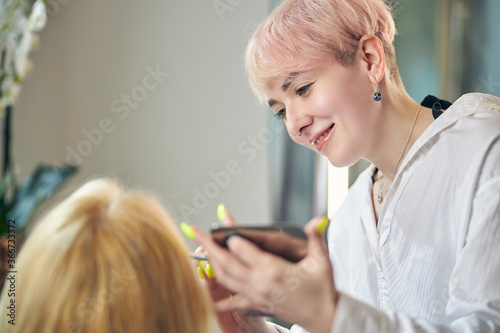 Joyful young female communicating with her client