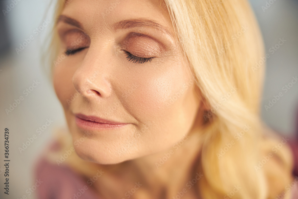 Portrait of mature woman demonstrating her makeup Portrait of mature woman demonstrating her makeup