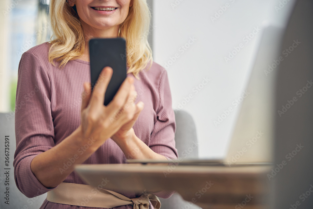 Close up of pleased female reading message Close up of pleased female reading message