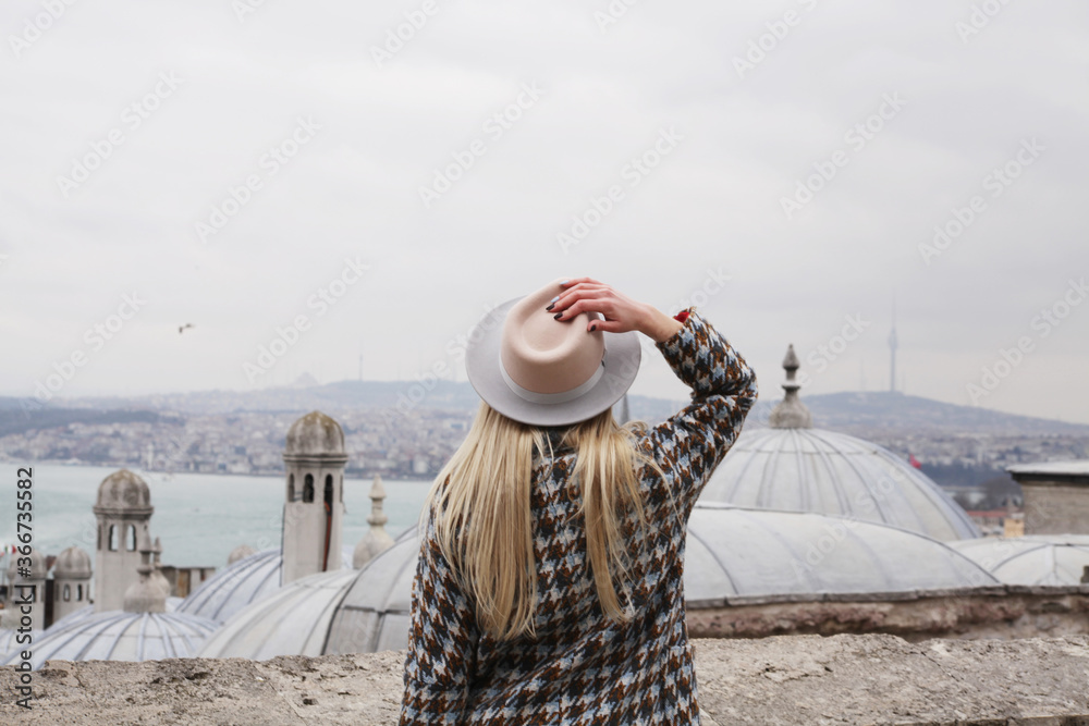 Tourist girl looking to the city landscape in Istanbul.