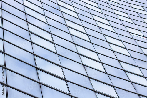 windows of a modern building with reflection of the sky