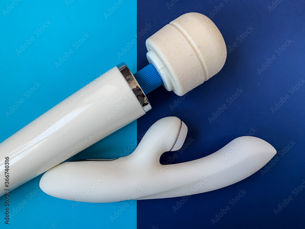 Fototapeta premium Sex toys. Two white vibrators on a blue background. Useful for adult, sex shop