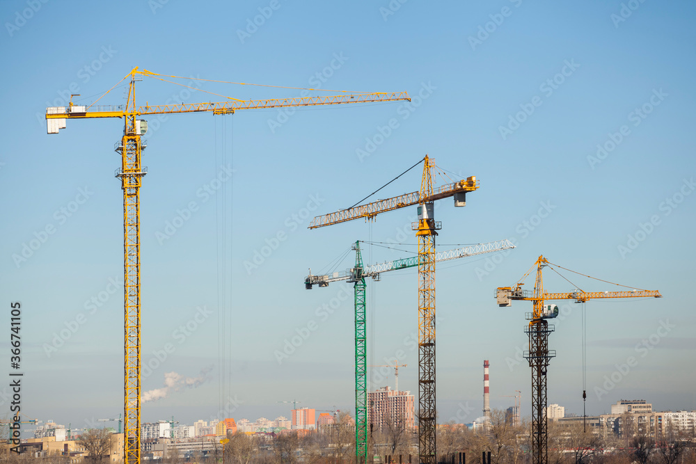 construction site with cranes against the blue sky