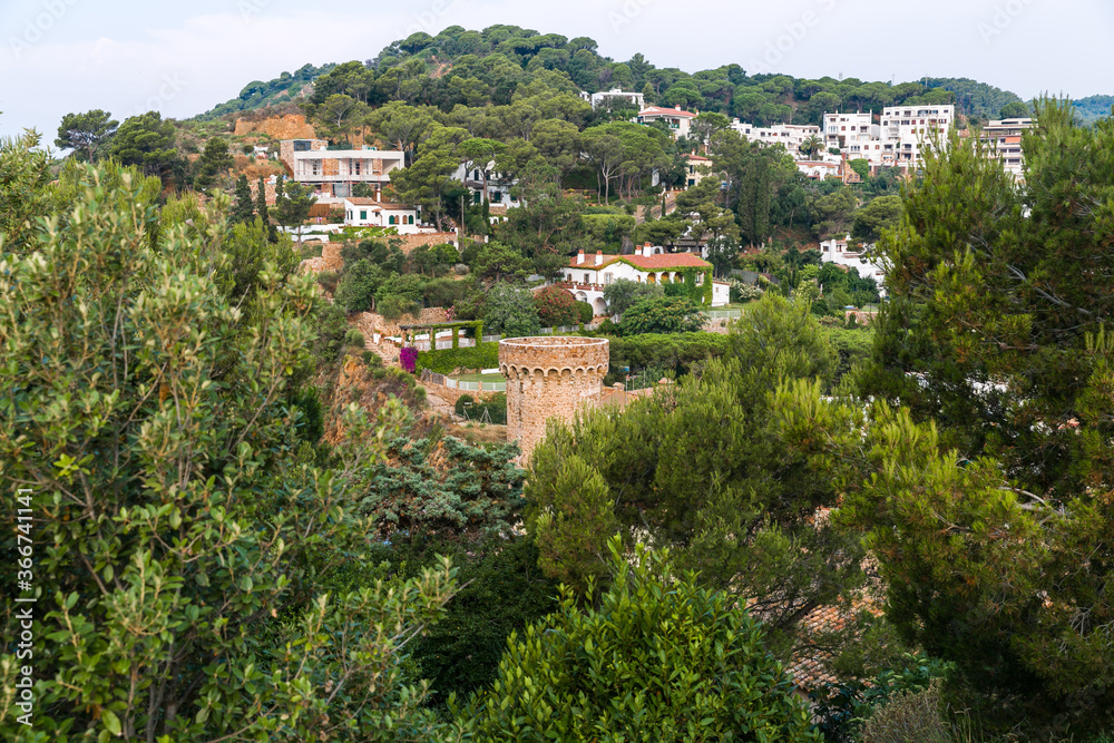 The town of Tossa de Mar from above. City through a pine forest. City on the mountain. City from the top of the fortress.