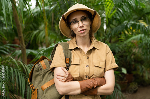 Принти на полотні Close up portrait of woman botanist dressed in safari style in greenhouse