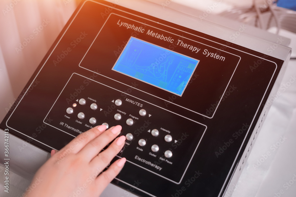 doctor setting up pressotherapy machine for slimming in spa salon doctor setting up pressotherapy machine for slimming in spa salon