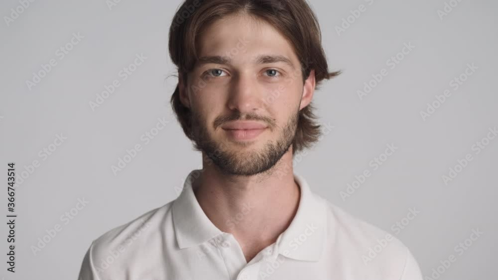 Portrait of handsome bearded guy confidently looking in camera over white background Portrait of handsome bearded guy confidently looking in camera over white background