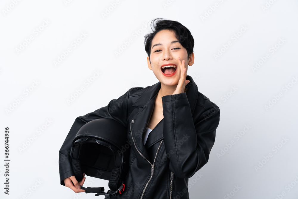 Young Asian girl with a motorcycle helmet over isolated white background shouting with mouth wide open Young Asian girl with a motorcycle helmet over isolated white background shouting with mouth wide open