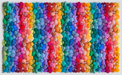 Colored balls and skiens of yarn for knitting. Top view. Rainbow colors. Color vertical gradient.