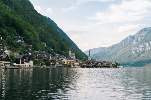 Austria, Hallstatt UNESCO historical village. Scenic picture-postcard view of famous alps resort mountain village in Austrian Alps in Salzkammergut area at beautiful light in summer. Swans on lake.