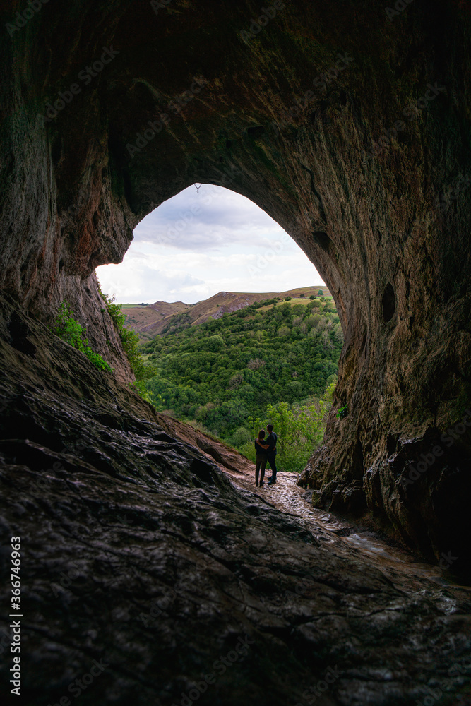 cave in the mountains with two people 