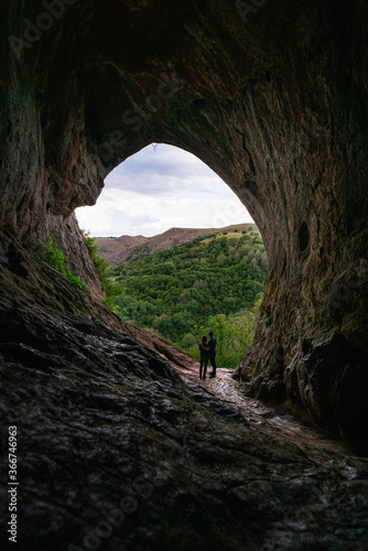 cave in the mountains with two people 