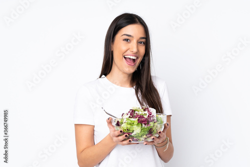 Young woman with salad isolated on white background
