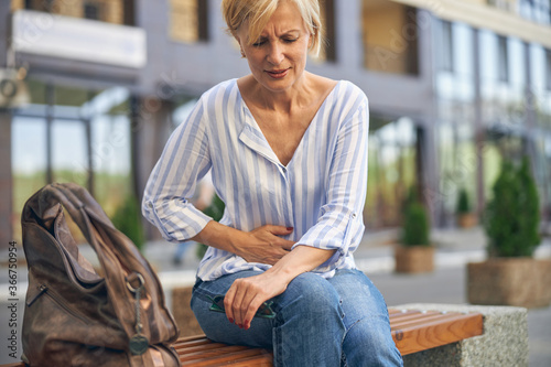 Bilde på lerret Mature Caucasian lady experiencing a severe stomachache