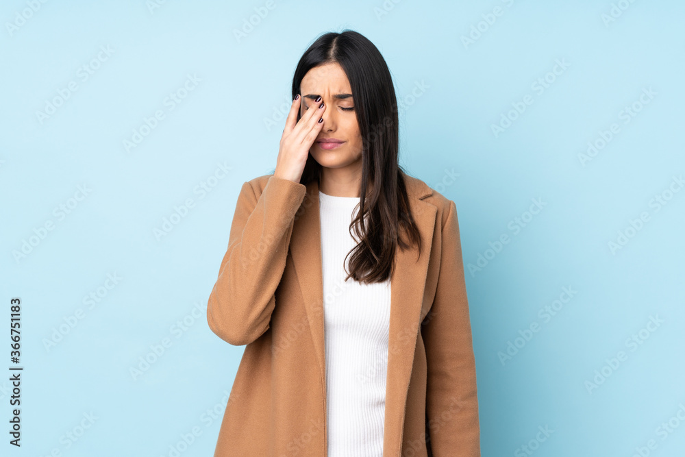 Young caucasian woman isolated on blue background with headache Young caucasian woman isolated on blue background with headache