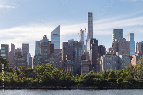 Skyscrapers along the East River in the Midtown Manhattan Skyline in New York City with Roosevelt Island © James