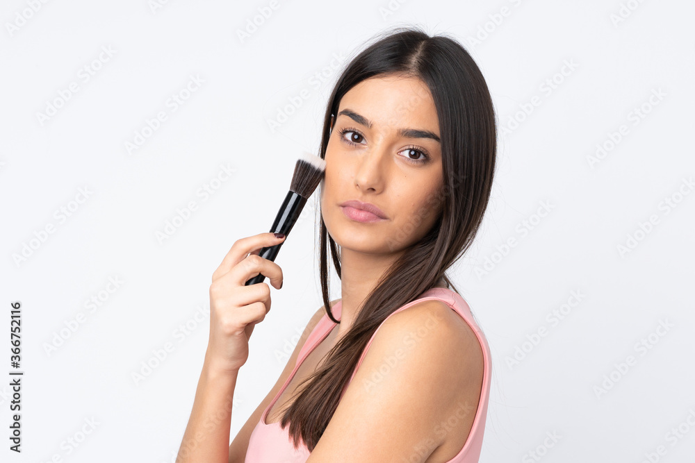 Young caucasian woman isolated on white background holding makeup brush Young caucasian woman isolated on white background holding makeup brush