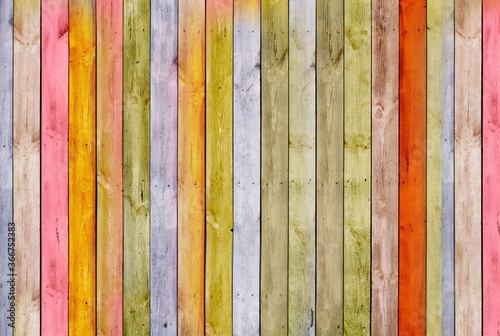 The wall is made of pine multi-color wooden Board. Texture or background