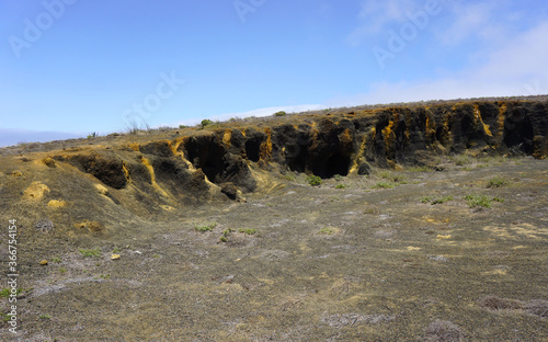 Black and yellow volcanic caves in Teno Alto, Tenerife, Canary Islands, Spain. Dry volcanic landscape on a sunny day.       