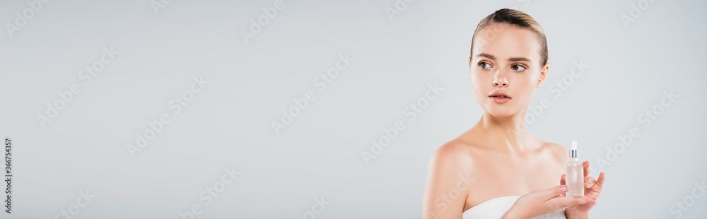 panoramic shot of woman holding bottle with serum isolated on grey panoramic shot of woman holding bottle with serum isolated on grey