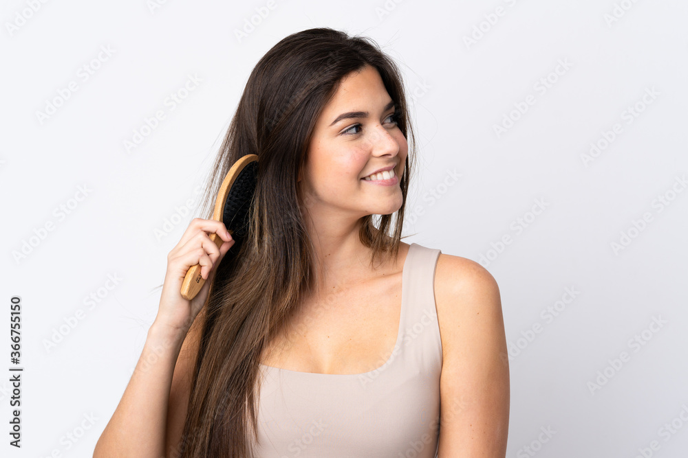 Teenager Brazilian girl with hair comb over isolated background Teenager Brazilian girl with hair comb over isolated background