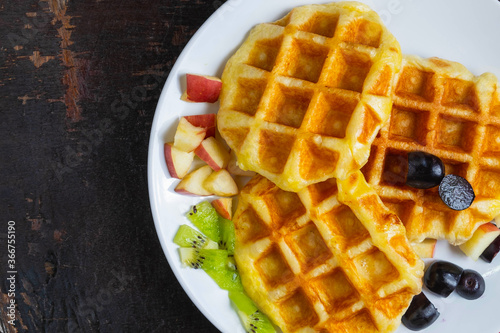 Delicious waffles in a plate on the table