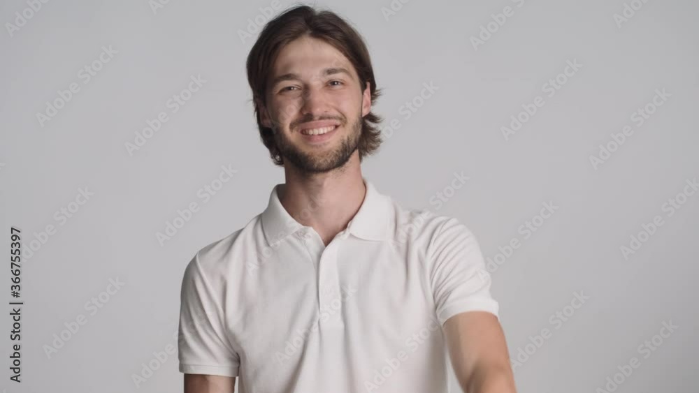 Attractive stylish guy confidently showing you gesture and thumb up on camera over white background. Like expression Attractive stylish guy confidently showing you gesture and thumb up on camera over white background. Like expression
