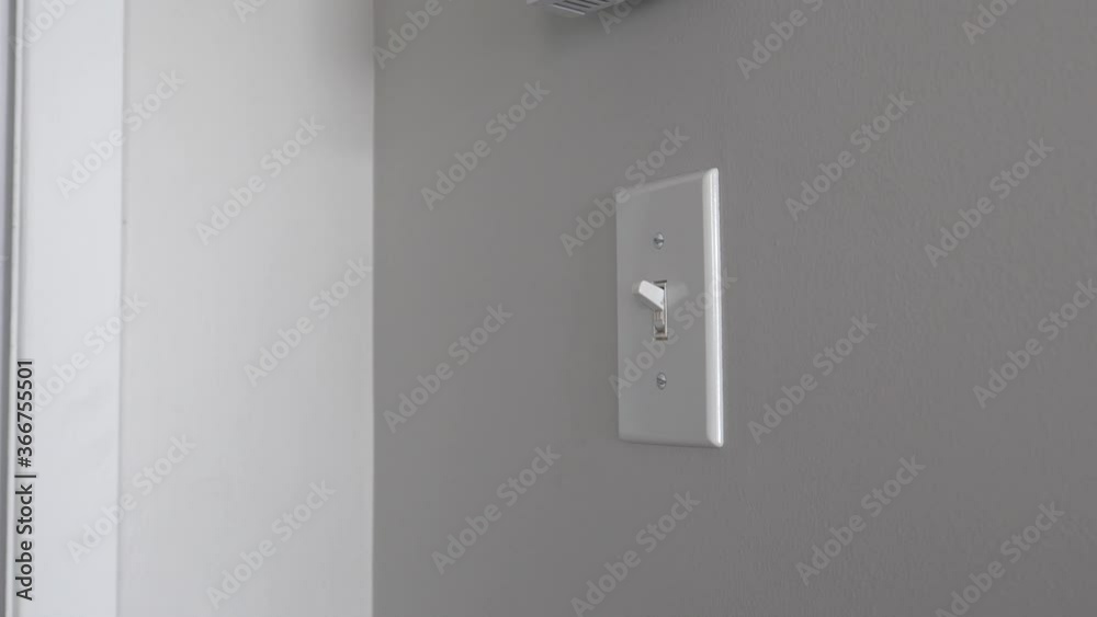 Man with a fake arm and hand switching the lights ON and OFF by himself. Handicap person working with a fake limb. Closeup shot. Man with a fake arm and hand switching the lights ON and OFF by himself. Handicap person working with a fake limb. Closeup shot.