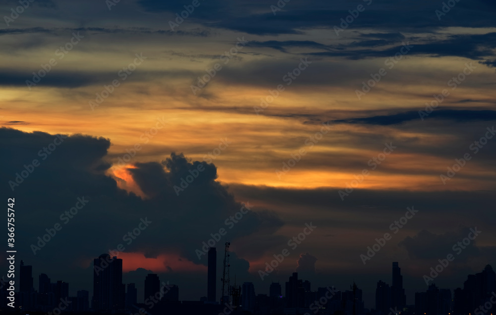 Sunset over a city with raincloud , Bangkok, Thailand