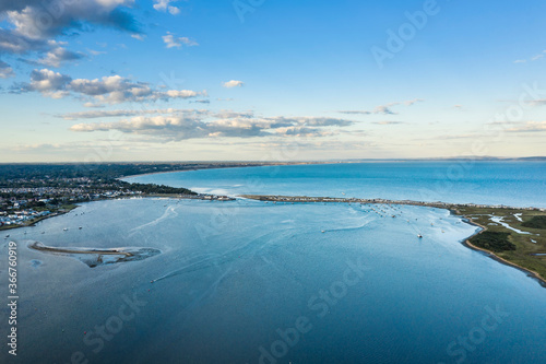 Beautiful drone landscape image of tidal inlet at Christchurch Harbour on English South coast during Summer evening