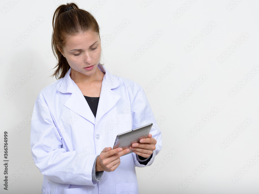Portrait of young beautiful woman doctor against white background Portrait of young beautiful woman doctor against white background