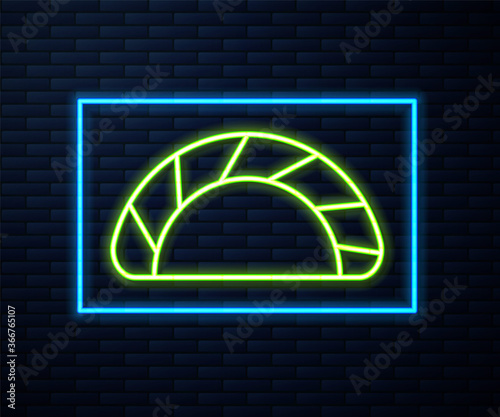 Glowing neon line Dumpling icon isolated on brick wall background. Traditional chinese dish. Vector.