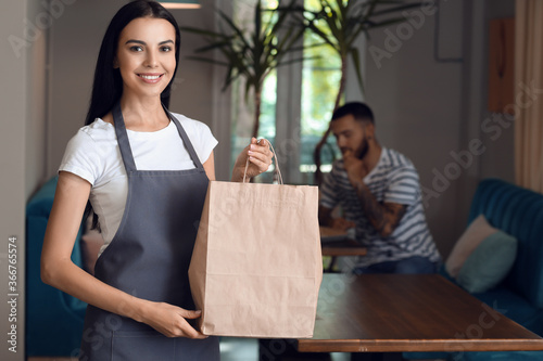 Young waitress with food fo...