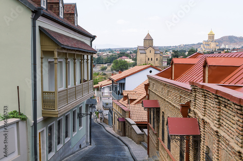 View over the Sameba Cathedral through historical houses in Tbilisi, capital of Georgia